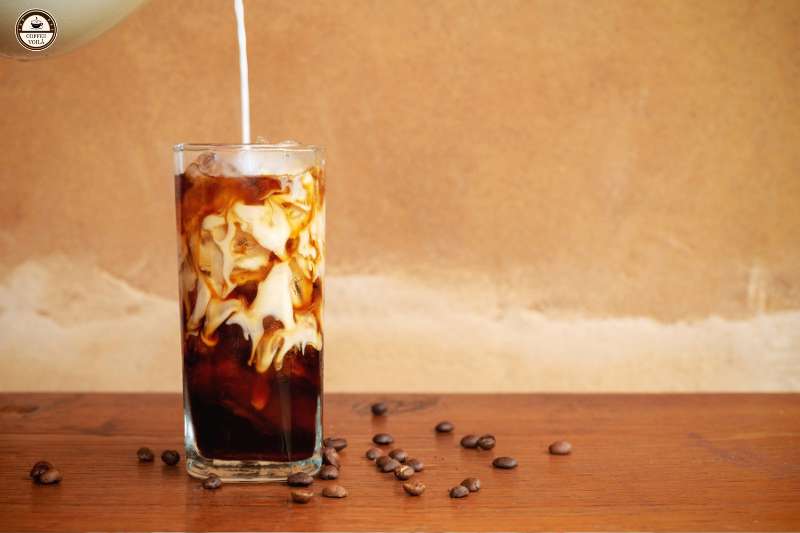 pour caramel syrup into cold brew